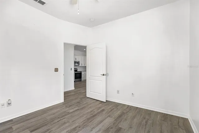 a view of a hallway with wooden floor