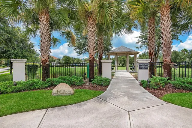 a view of a house with a small yard plants and palm trees
