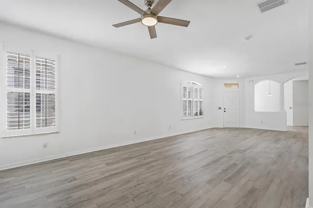 wooden floor in an empty room with a window