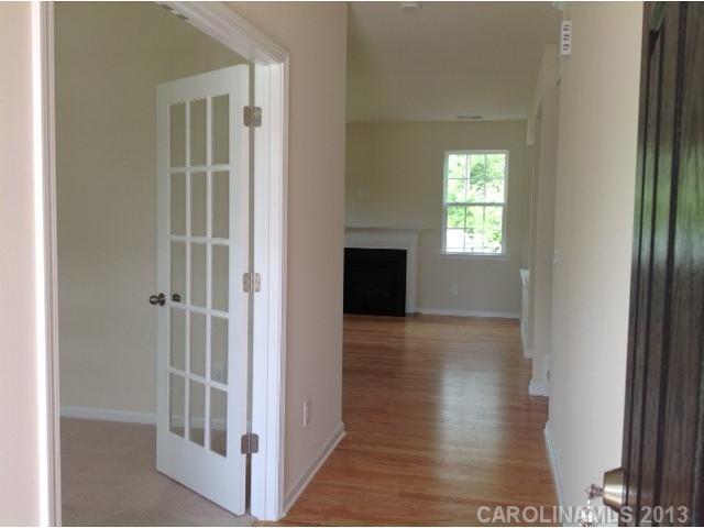78047 Rillstone Drive, Unit 236 Lancaster, SC 29720 - Photo 3 of 16 a view of a hallway with wooden floor and a living room