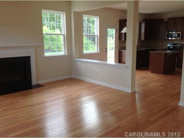 78047 Rillstone Drive, Unit 236 Lancaster, SC 29720 - Photo 5 of 16 an empty room with windows and fireplace