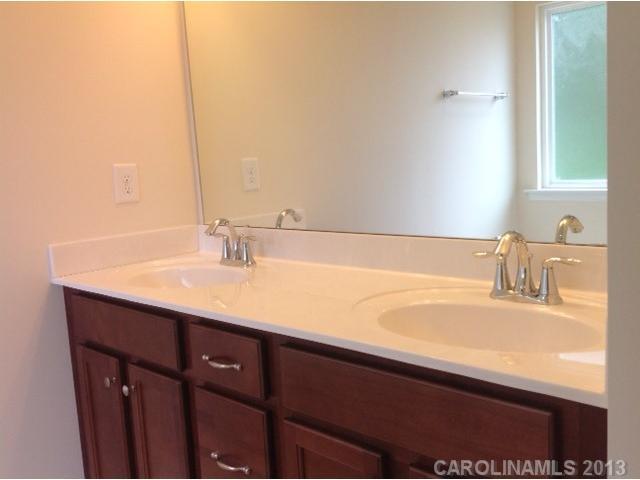 78047 Rillstone Drive, Unit 236 Lancaster, SC 29720 - Photo 10 of 16 a bathroom with a sink and a mirror