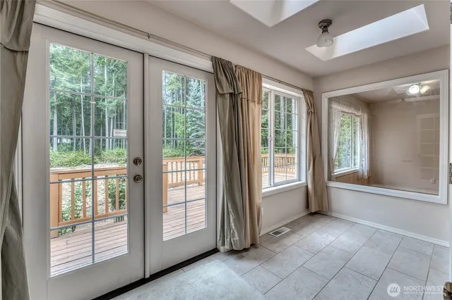 a view of an empty room with a fireplace and a large window