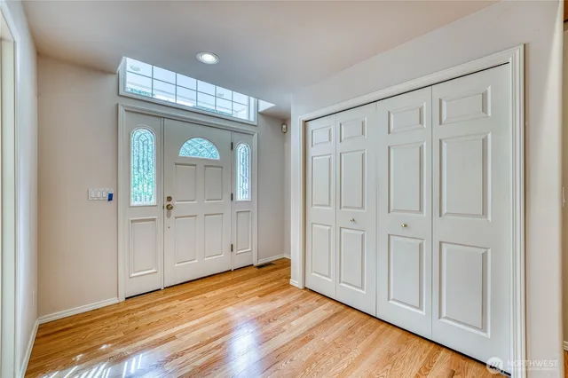 a view of a hallway with wooden floor