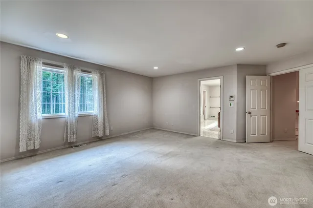 a bathroom with a tub double vanity sink and mirror