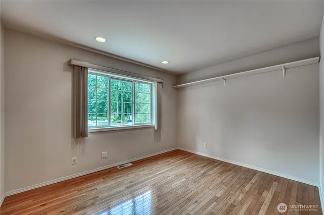 a view of a room with wooden floor and white walls