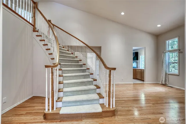 a view of entryway and hall with wooden floor