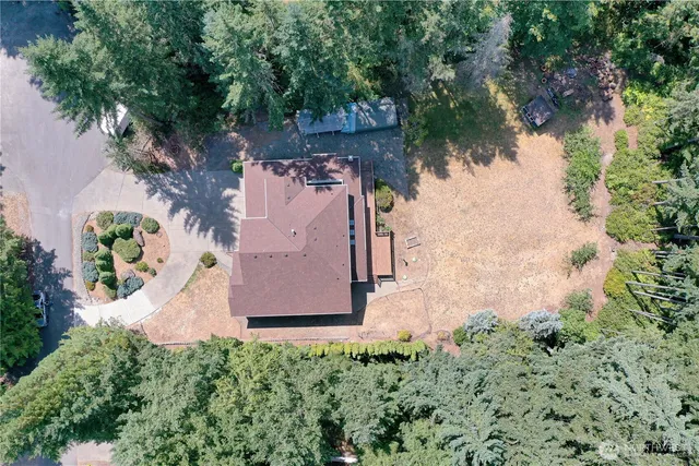 an aerial view of a house with a yard and lake view