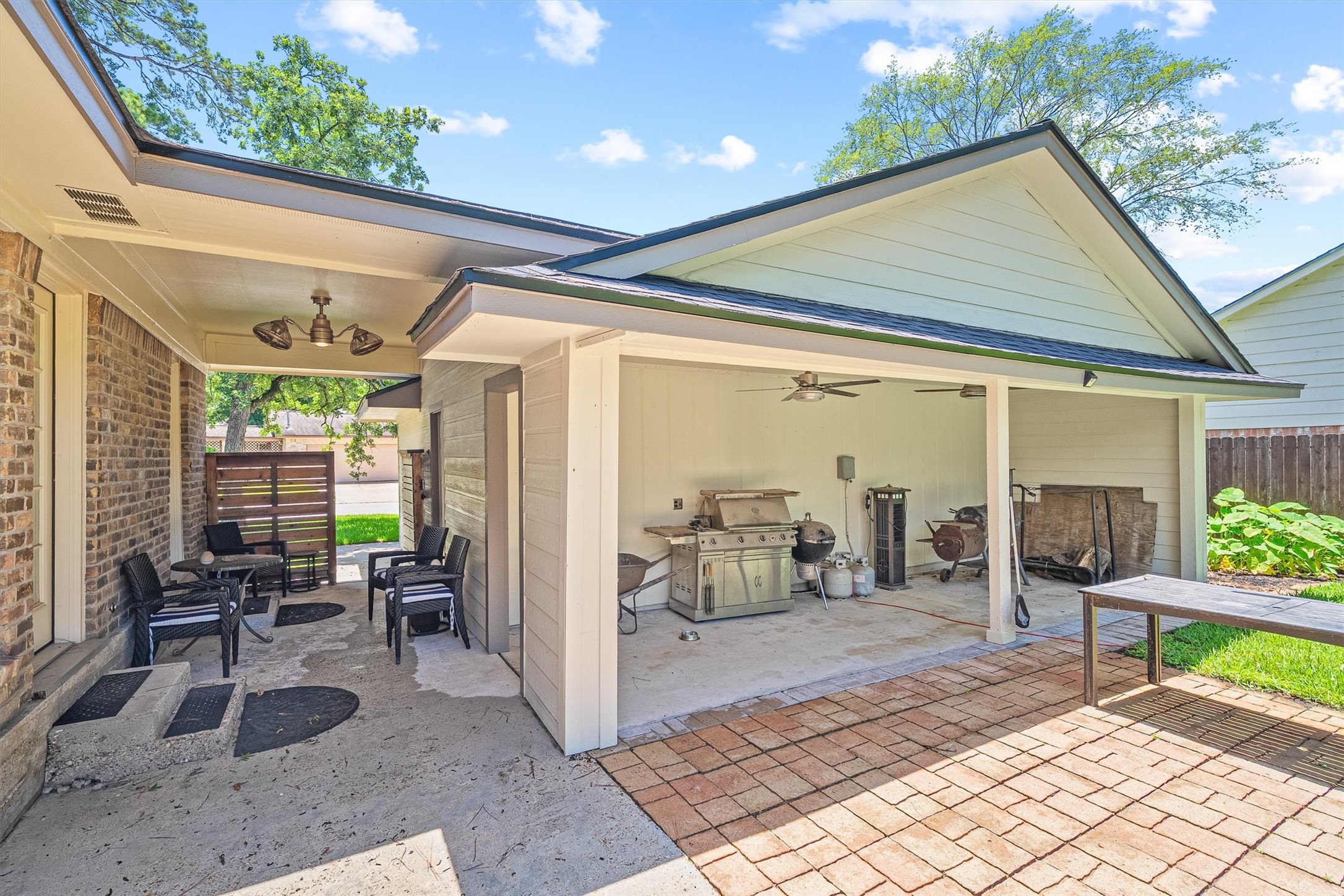 826 North Rivershire Drive Conroe, TX 77304 - Photo 32 of 46 The covered patio and breezeway connect the home to the backyard in the most Texas way possible. Ceiling fan overhead, brick paver flooring, and an open air entertaining space that makes outdoor living feel like a natural extension of the inside.