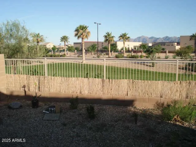 a view of a park with iron fence