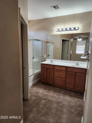 a spacious bathroom with a granite countertop sink and a mirror