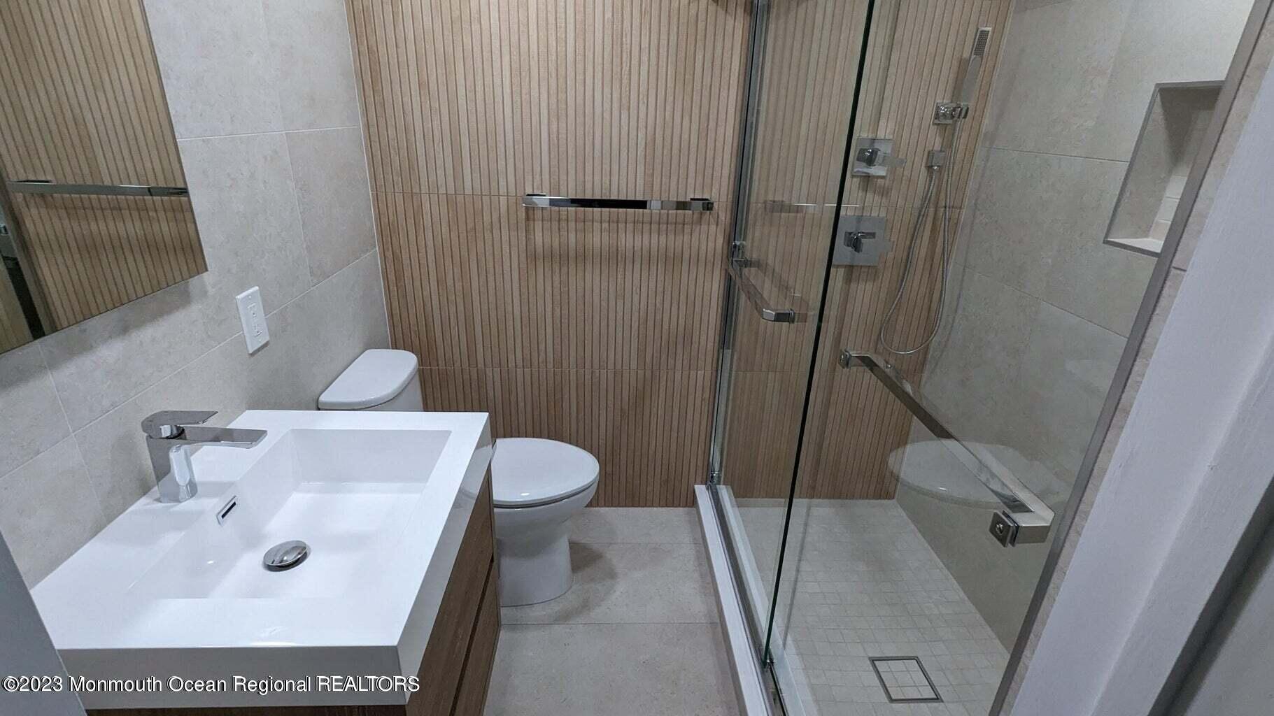 254 Garfield Avenue Oakhurst, NJ 07755 - Photo 12 of 26 a bathroom with a sink a toilet and shower