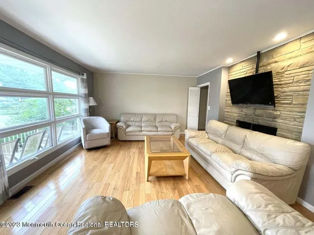 a living room with a couch and large windows