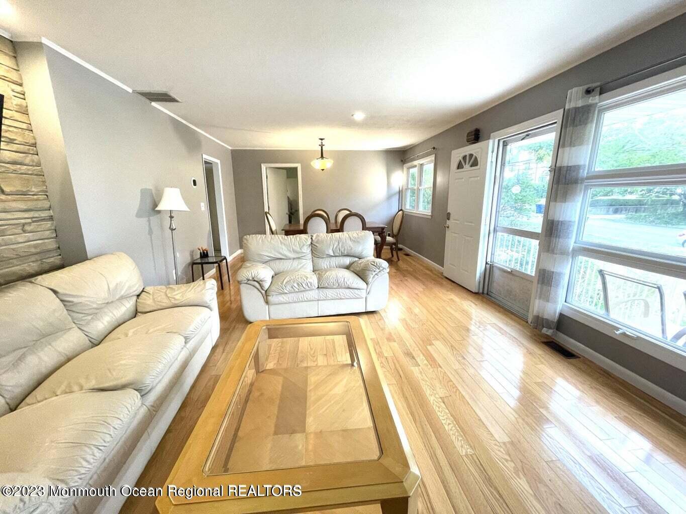 254 Garfield Avenue Oakhurst, NJ 07755 - Photo 19 of 26 a living room with a couch and large windows