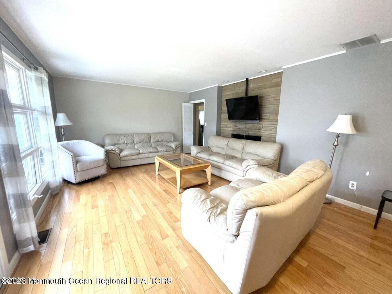 254 Garfield Avenue Oakhurst, NJ 07755 - Photo 20 of 26 a living room with furniture and a flat screen tv