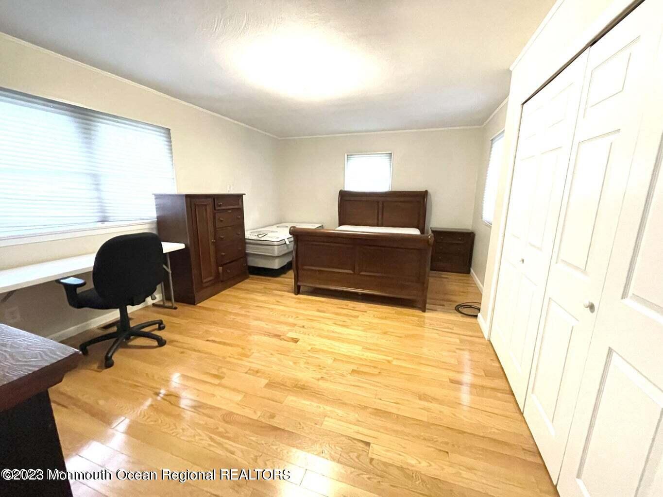 254 Garfield Avenue Oakhurst, NJ 07755 - Photo 24 of 26 a bedroom with a bed and wooden floor