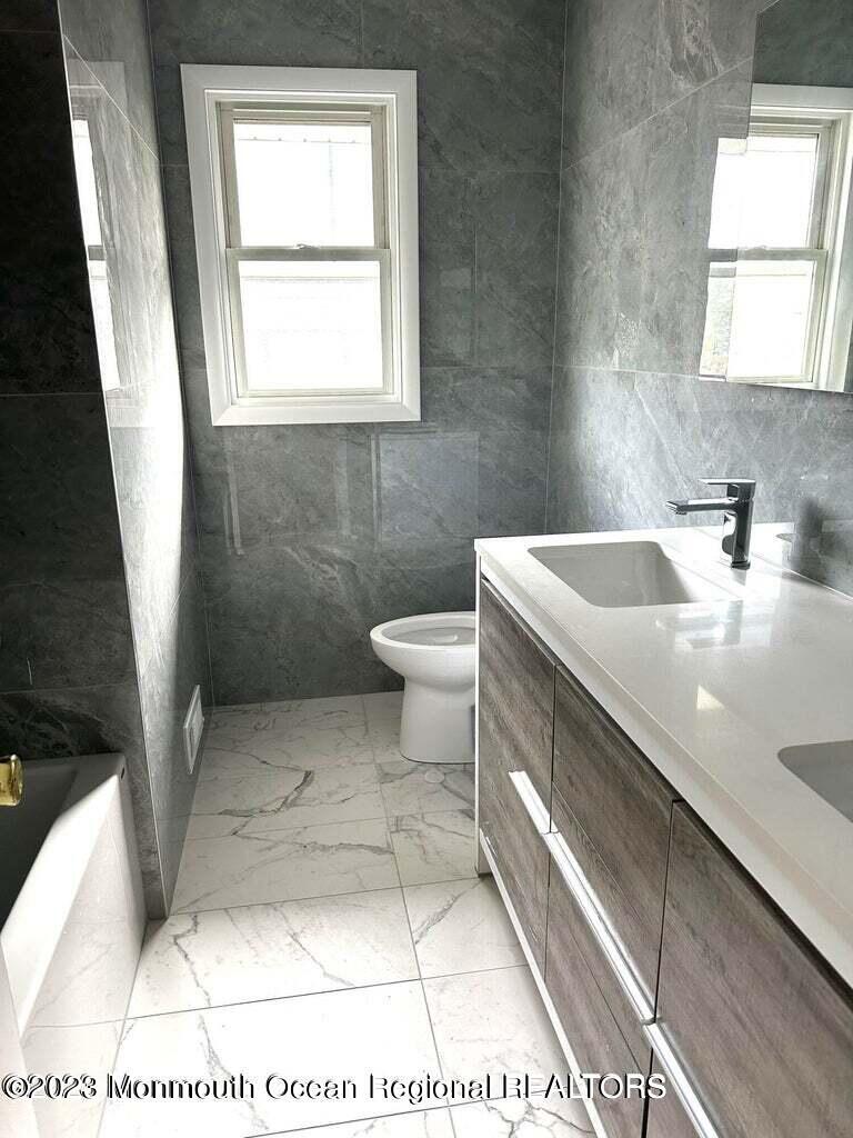 254 Garfield Avenue Oakhurst, NJ 07755 - Photo 3 of 26 a bathroom with a sink toilet and window