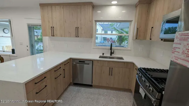 a kitchen with sink cabinets and window
