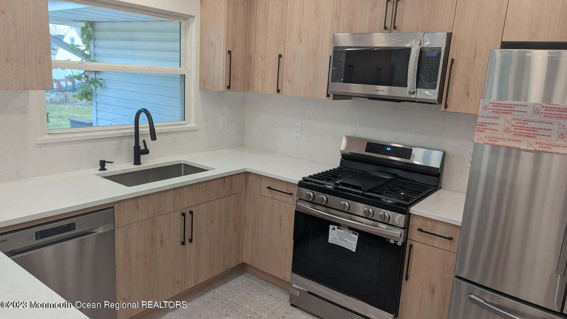 254 Garfield Avenue Oakhurst, NJ 07755 - Photo 8 of 26 a kitchen with a stove and a microwave