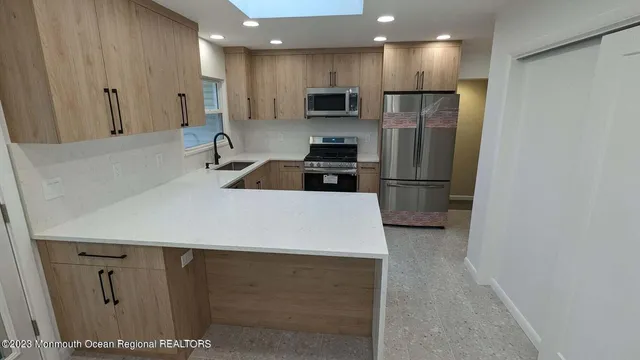 a kitchen with stainless steel appliances a refrigerator and a sink