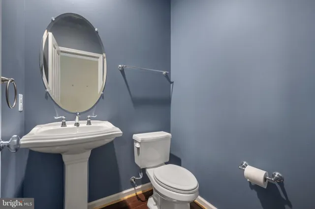 a view of a livingroom with wooden floor and windows