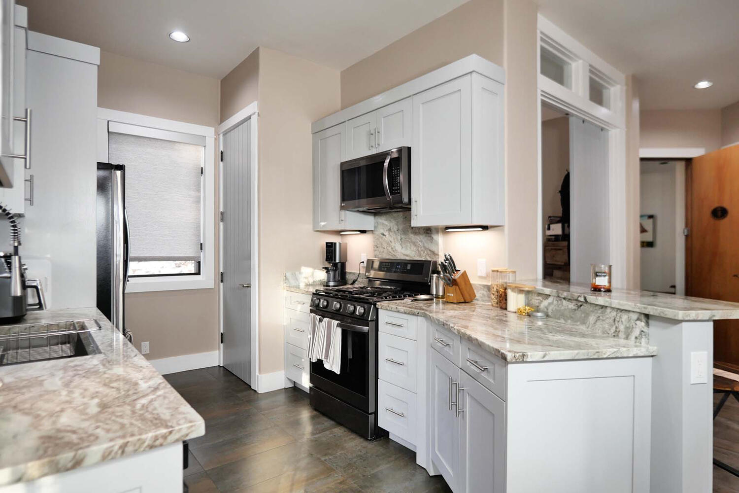404 Adams Ranch Road, Unit 1201 Mountain Village, CO 81435 - Photo 11 of 47 a kitchen with stainless steel appliances granite countertop a refrigerator stove and sink