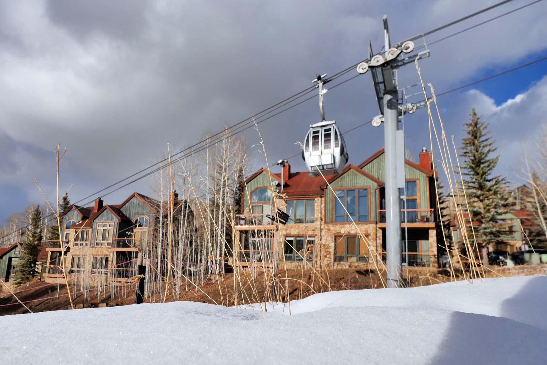404 Adams Ranch Road, Unit 1201 Mountain Village, CO 81435 - Photo 23 of 47 a view of a house with a street