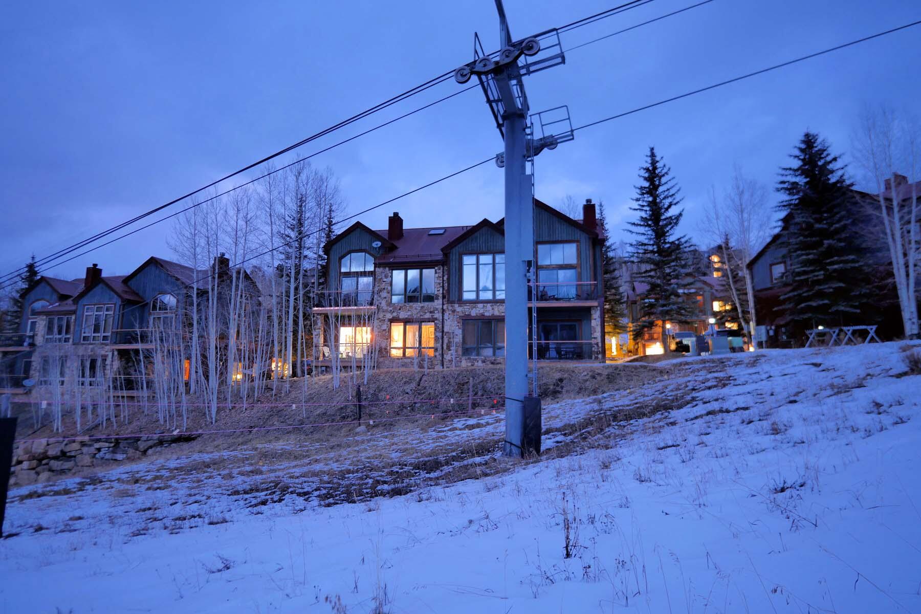 404 Adams Ranch Road, Unit 1201 Mountain Village, CO 81435 - Photo 24 of 47 a view of a house with a yard