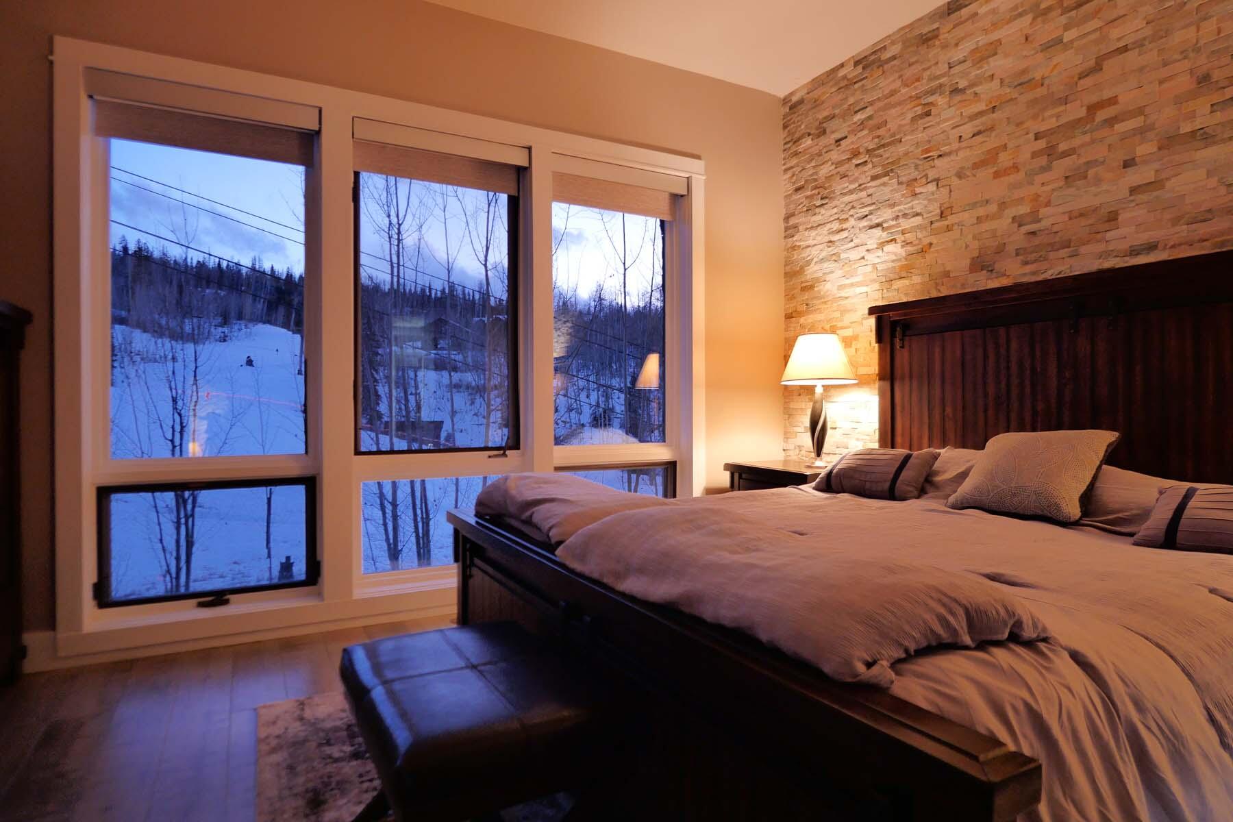 404 Adams Ranch Road, Unit 1201 Mountain Village, CO 81435 - Photo 30 of 47 a bedroom with a bed and two windows