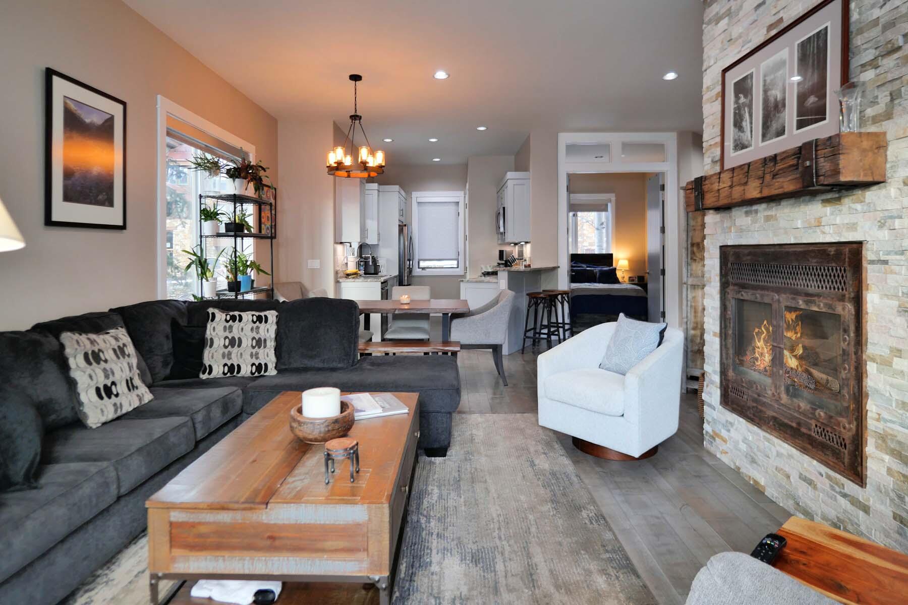 404 Adams Ranch Road, Unit 1201 Mountain Village, CO 81435 - Photo 10 of 47 a living room with furniture and a fireplace