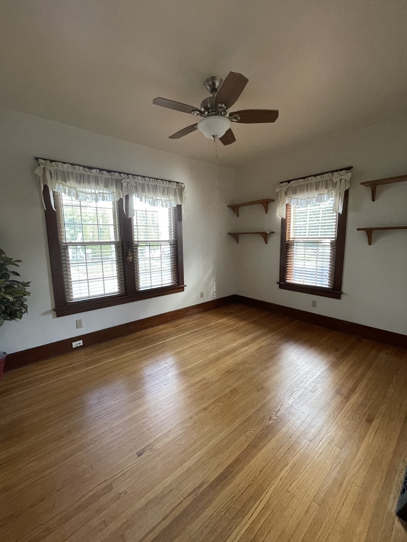 229 West Moore Street Ottawa, IL 61350 - Photo 10 of 33 a view of an empty room with wooden floor and a window