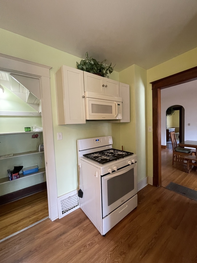 229 West Moore Street Ottawa, IL 61350 - Photo 14 of 33 a kitchen with wooden floors and a stove