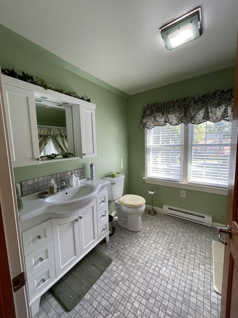 229 West Moore Street Ottawa, IL 61350 - Photo 32 of 33 a bathroom with a toilet sink and mirror