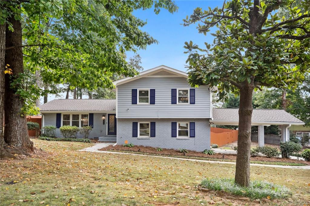 2216 Sterling Ridge Road Decatur, GA 30032 - Photo 1 of 1 a front view of a house with a garden and tree