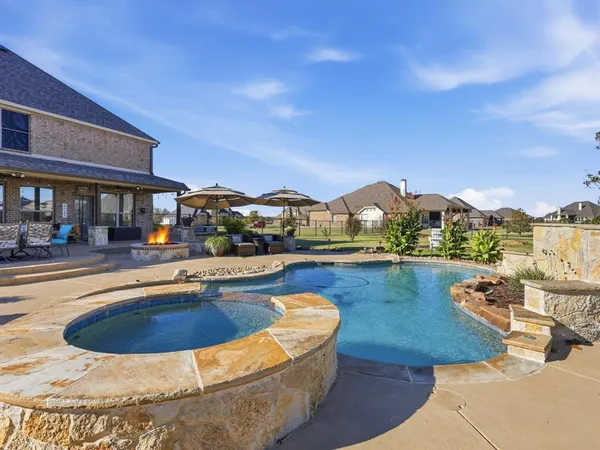 a view of a swimming pool and lounge chairs