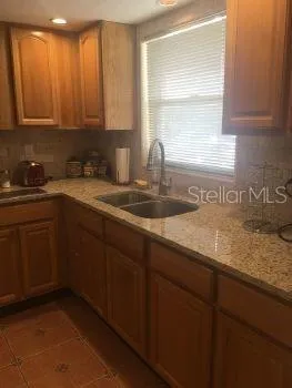 a kitchen with a sink cabinets and window