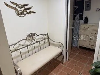 a bedroom with a bed and a mirror