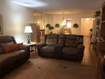 a living room with furniture and a lamp