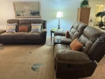 a living room with furniture and a lamp