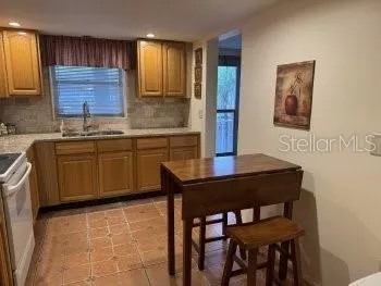 a kitchen with a sink cabinets and window