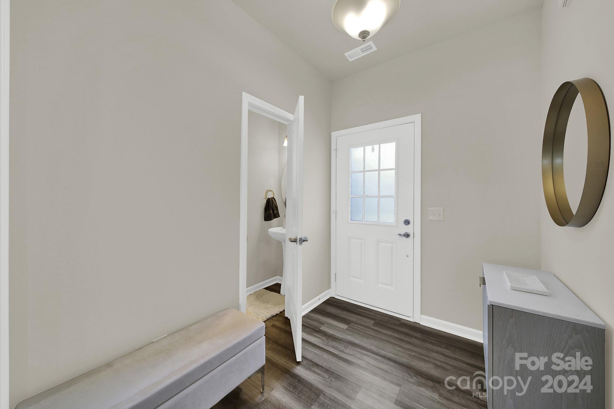 818 Canoe Song Road Fort Mill, SC 29708 - Photo 12 of 36 a view of a room with wooden floor and windows