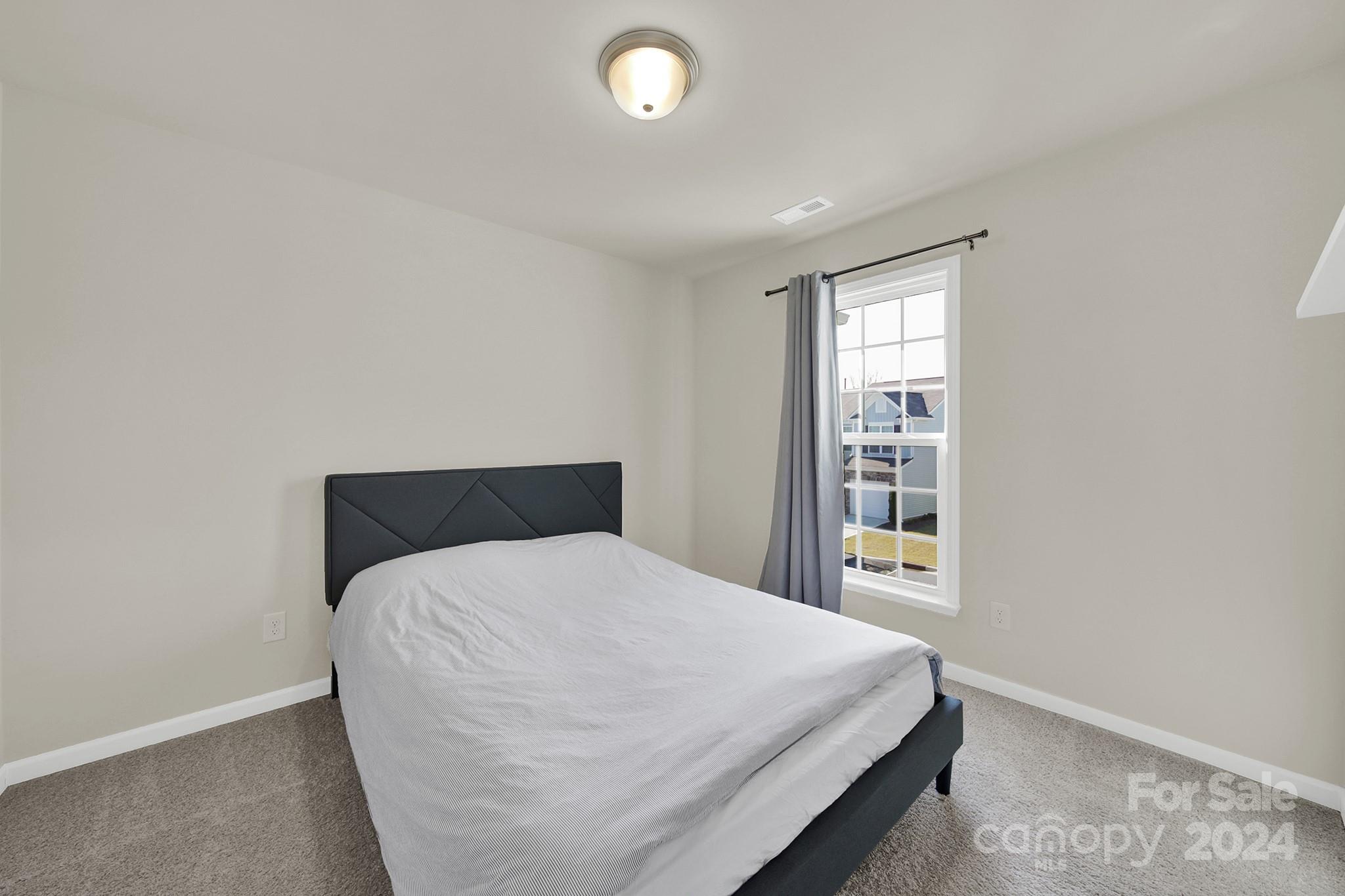 818 Canoe Song Road Fort Mill, SC 29708 - Photo 14 of 36 a bedroom with a bed and a window