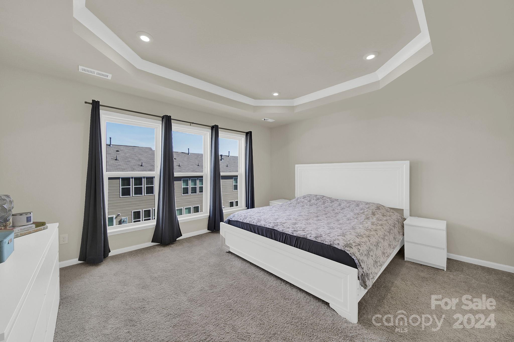 818 Canoe Song Road Fort Mill, SC 29708 - Photo 21 of 36 a spacious bedroom with a large bed and a large window