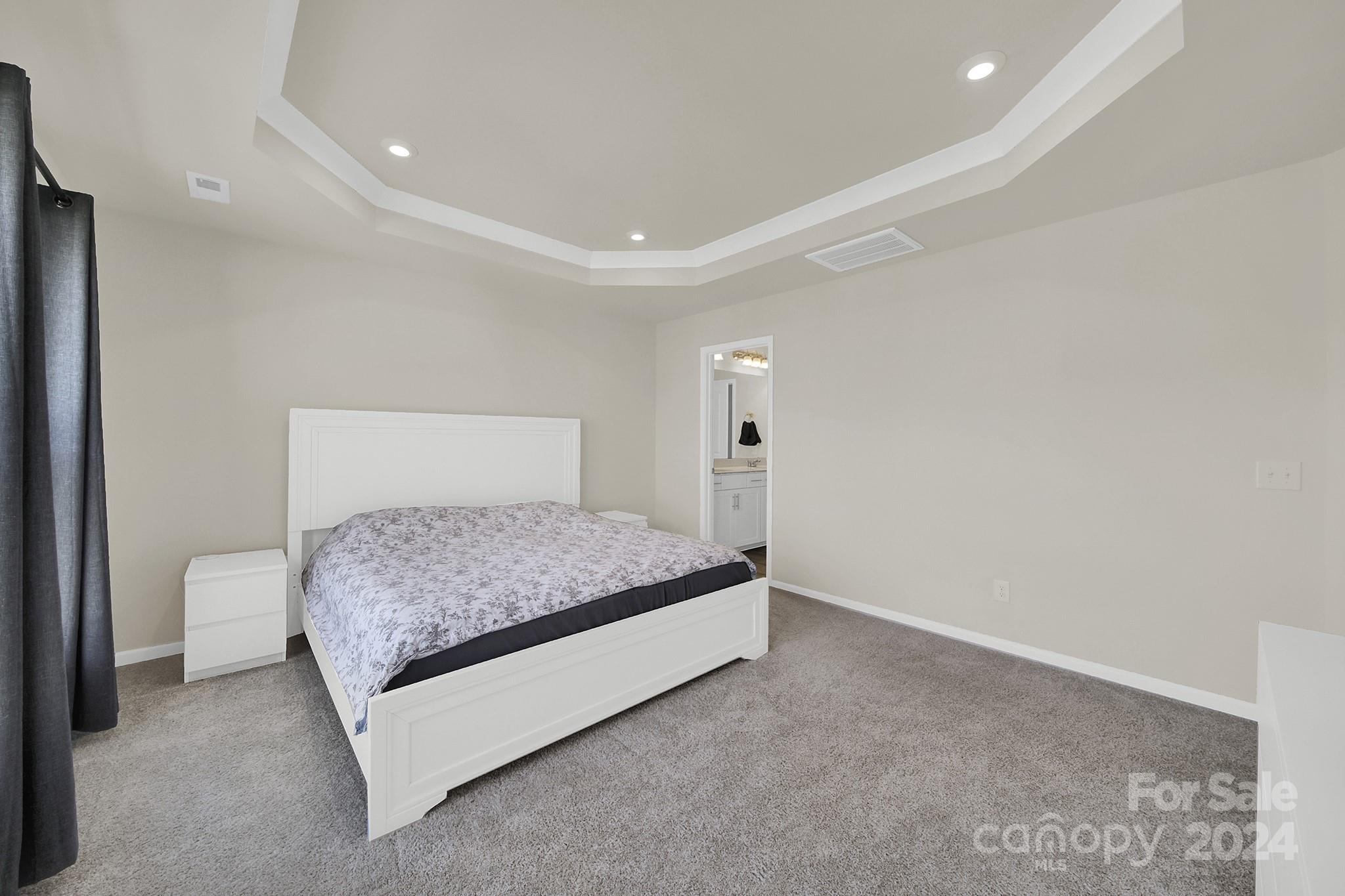 818 Canoe Song Road Fort Mill, SC 29708 - Photo 22 of 36 a bedroom with a bed and a lamp