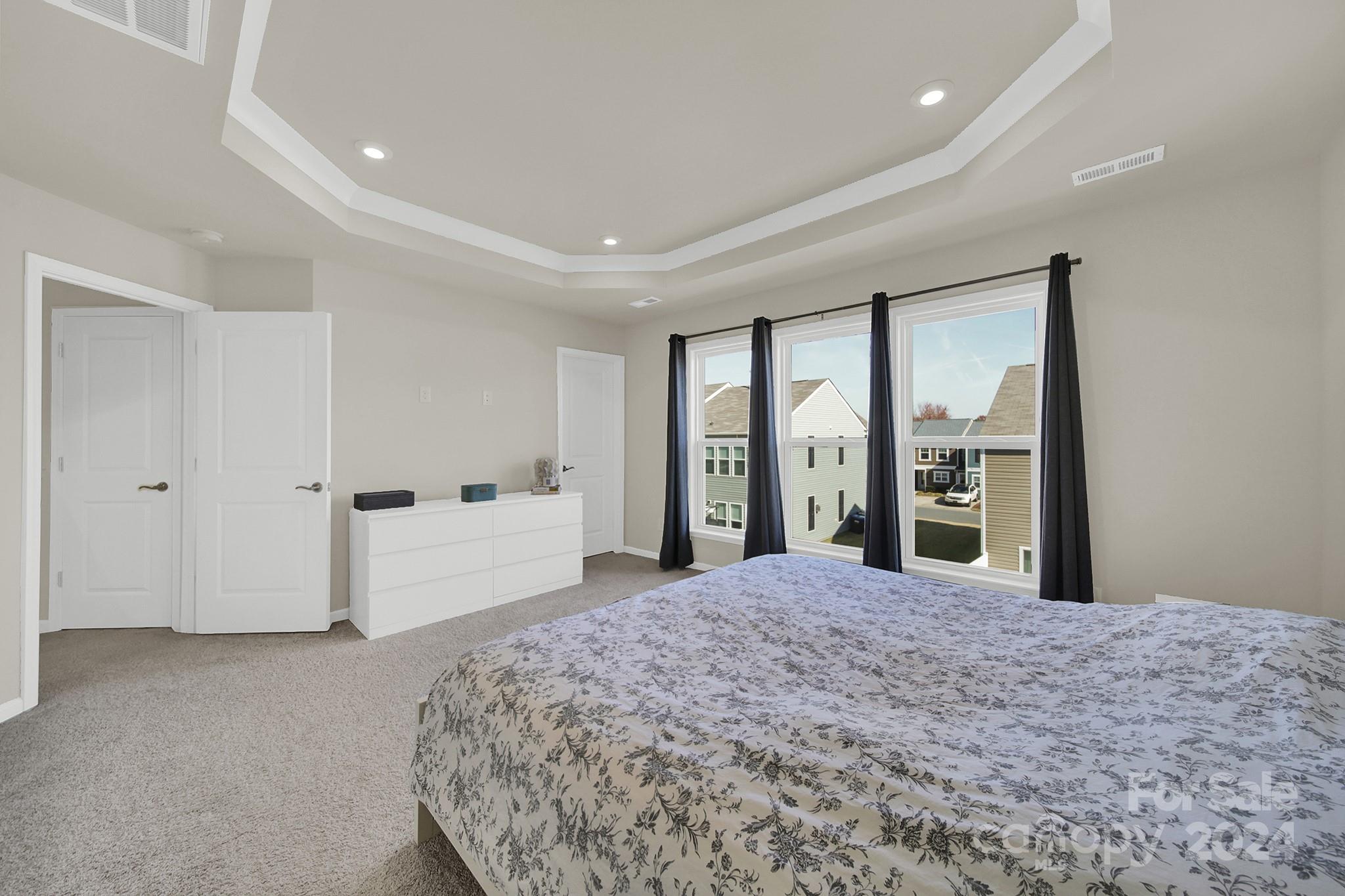 818 Canoe Song Road Fort Mill, SC 29708 - Photo 23 of 36 a large bedroom with a large bed and a large window