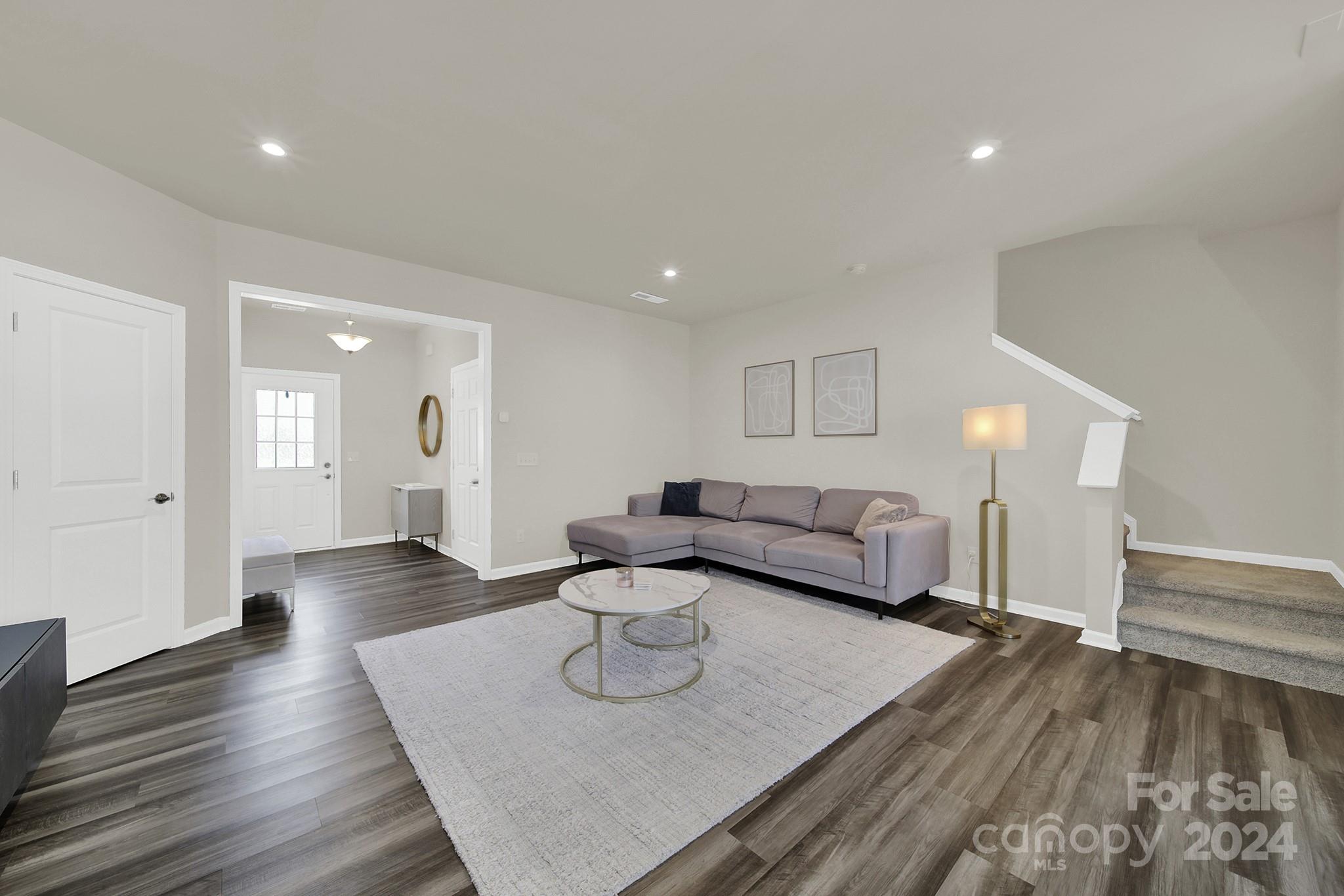 818 Canoe Song Road Fort Mill, SC 29708 - Photo 3 of 36 a living room with furniture and wooden floor