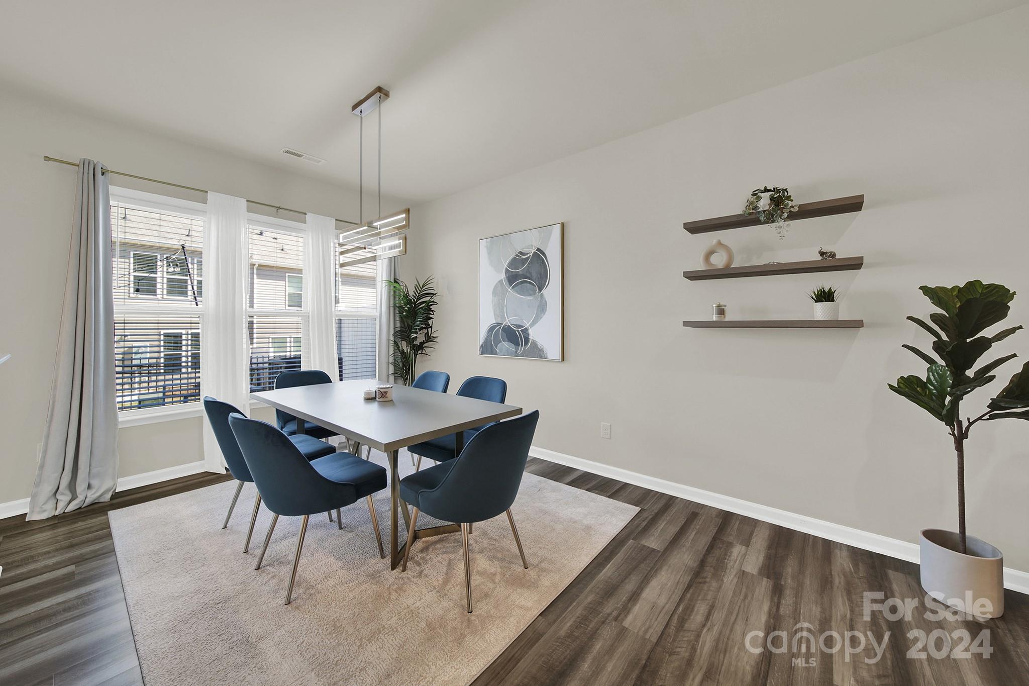 818 Canoe Song Road Fort Mill, SC 29708 - Photo 5 of 36 a view of a dining room with furniture window and wooden floor