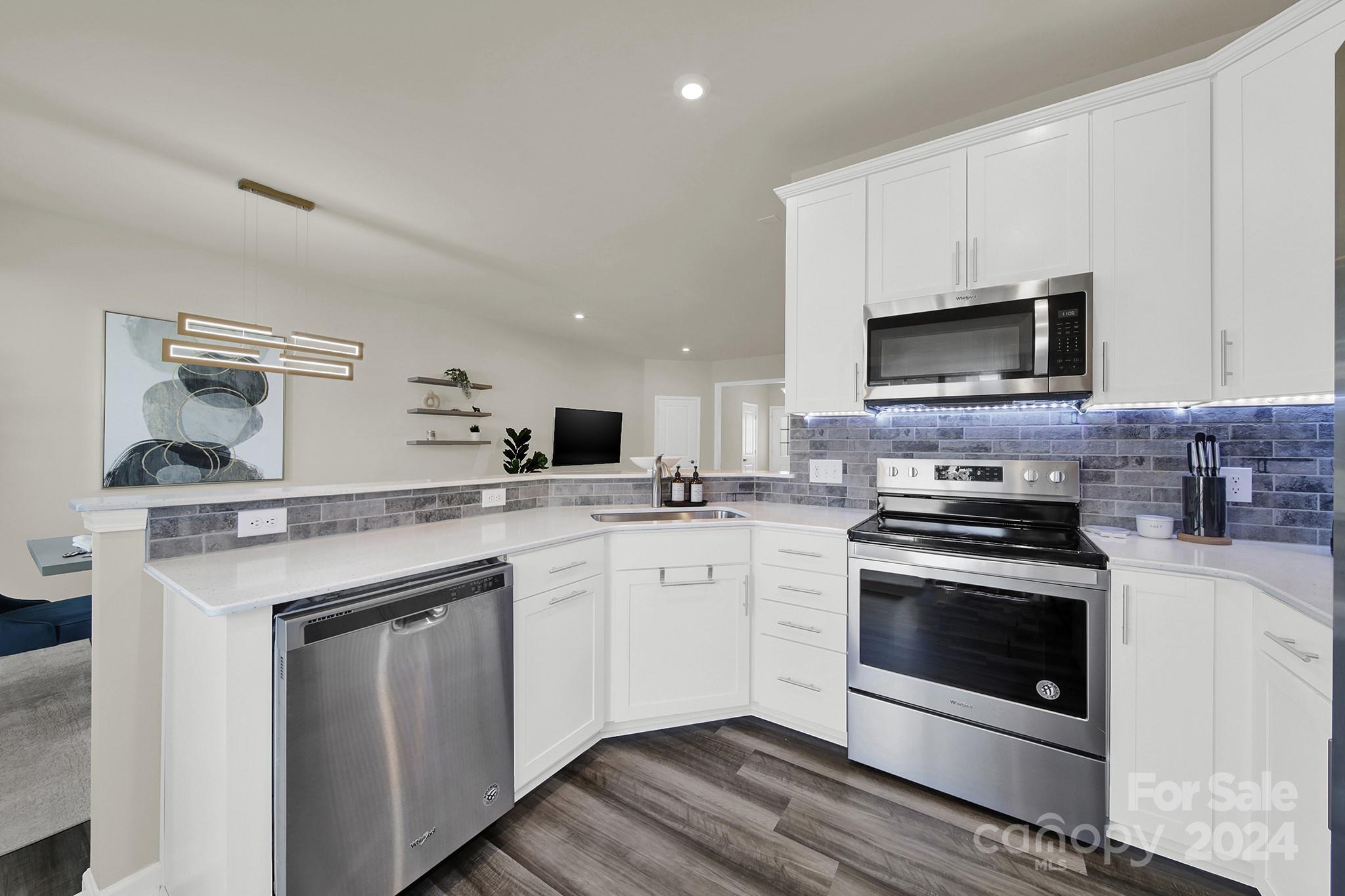 818 Canoe Song Road Fort Mill, SC 29708 - Photo 10 of 36 a kitchen with stainless steel appliances granite countertop a stove microwave and sink