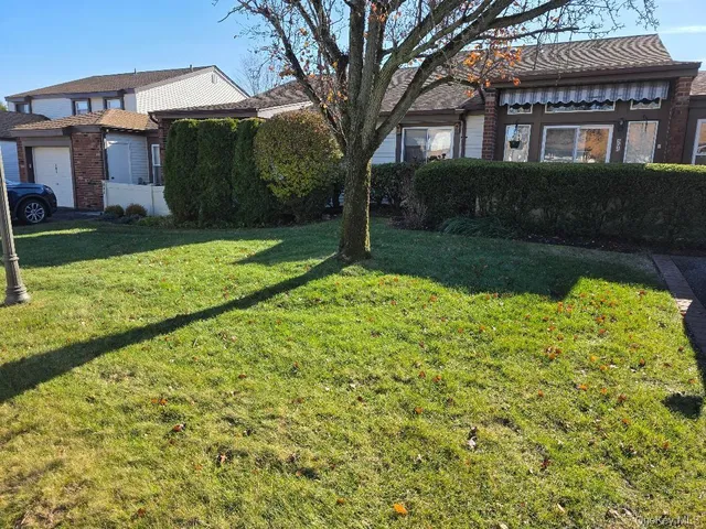 a view of a brick house with a yard