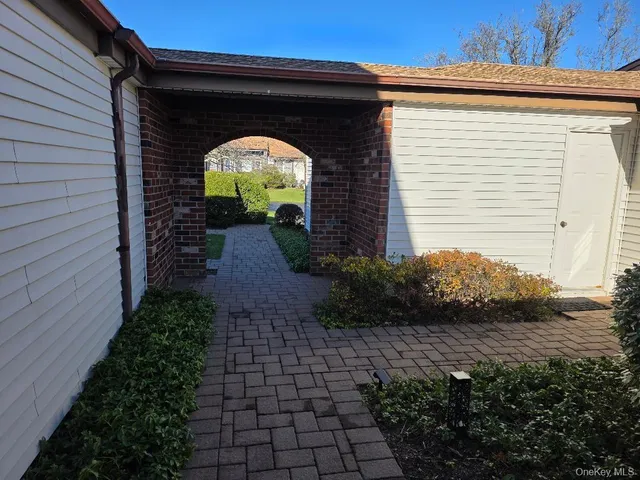 a view of a car parked in front of a house with a yard